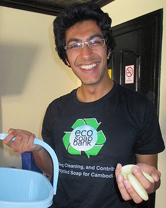 Samir holding a bucket of soap